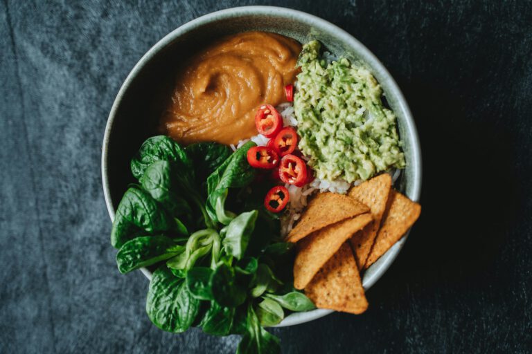 Delicious vegan bowl featuring avocado, rice, and fresh greens perfect for a healthy meal.
