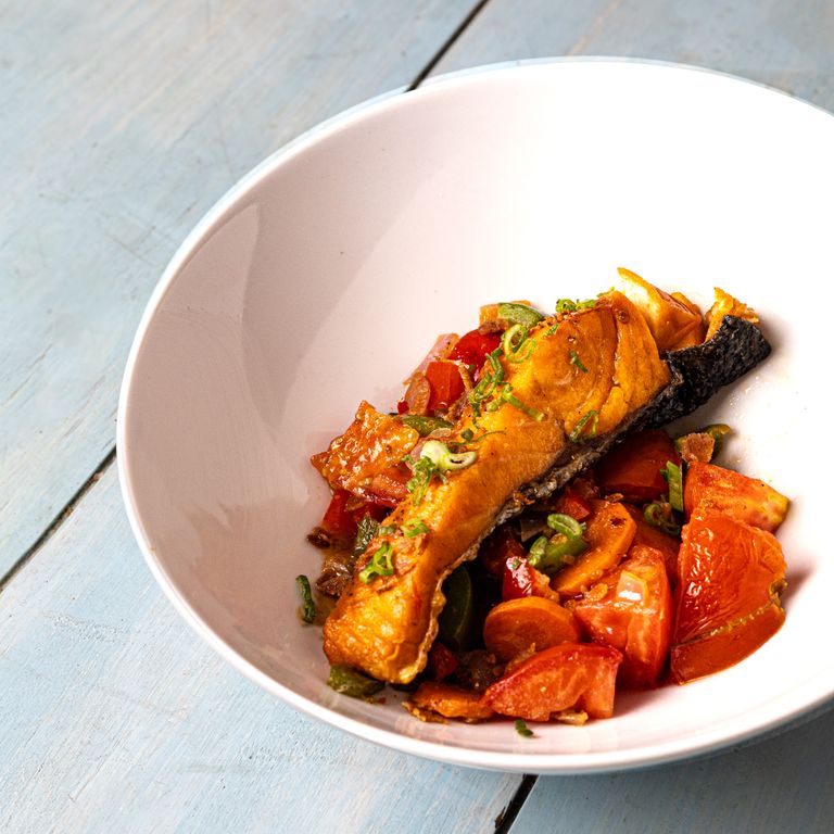 A tantalizing salmon fillet served with vibrant vegetables, perfect for seafood lovers.