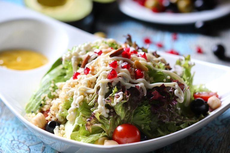 A vibrant vegetable salad with creamy dressing served in a stylish dish.