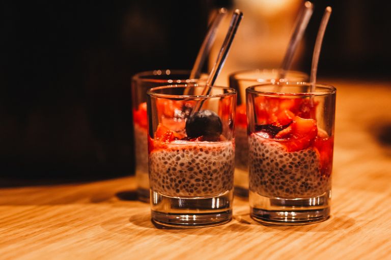 Close-up of delicious chia seed pudding topped with fresh berries, served in elegant glasses.