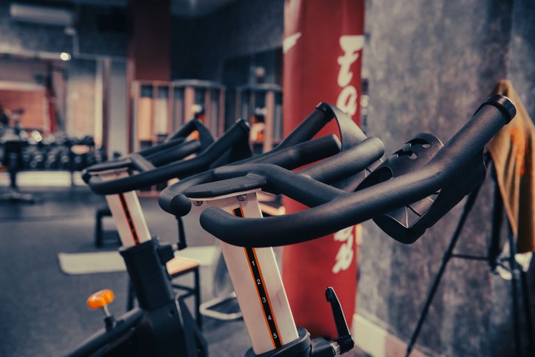 Close-up of modern indoor cycling equipment in a contemporary fitness center, highlighting sleek design and functionality.