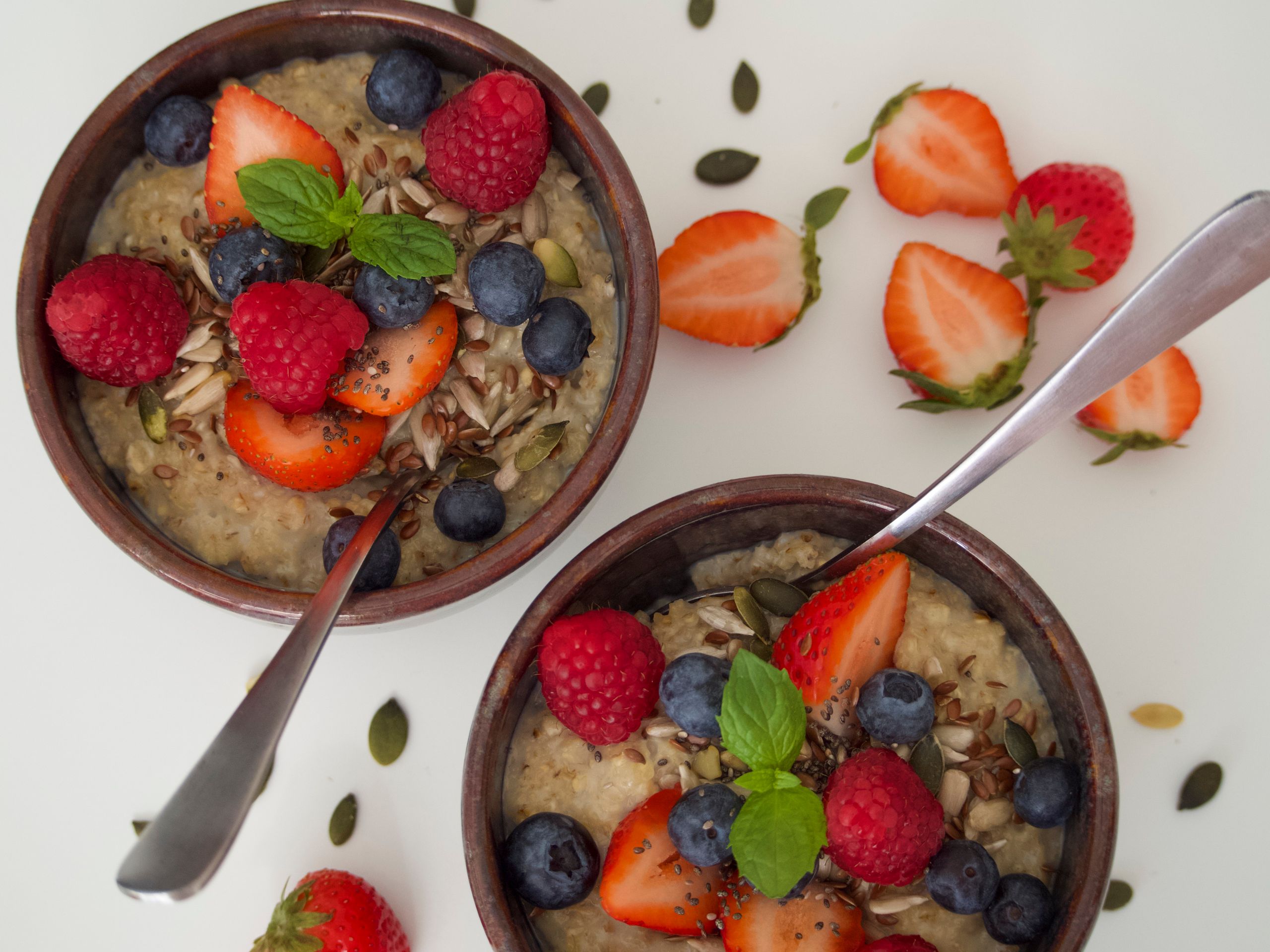 Delicious breakfast bowls topped with fresh berries and seeds for a nutritious start.