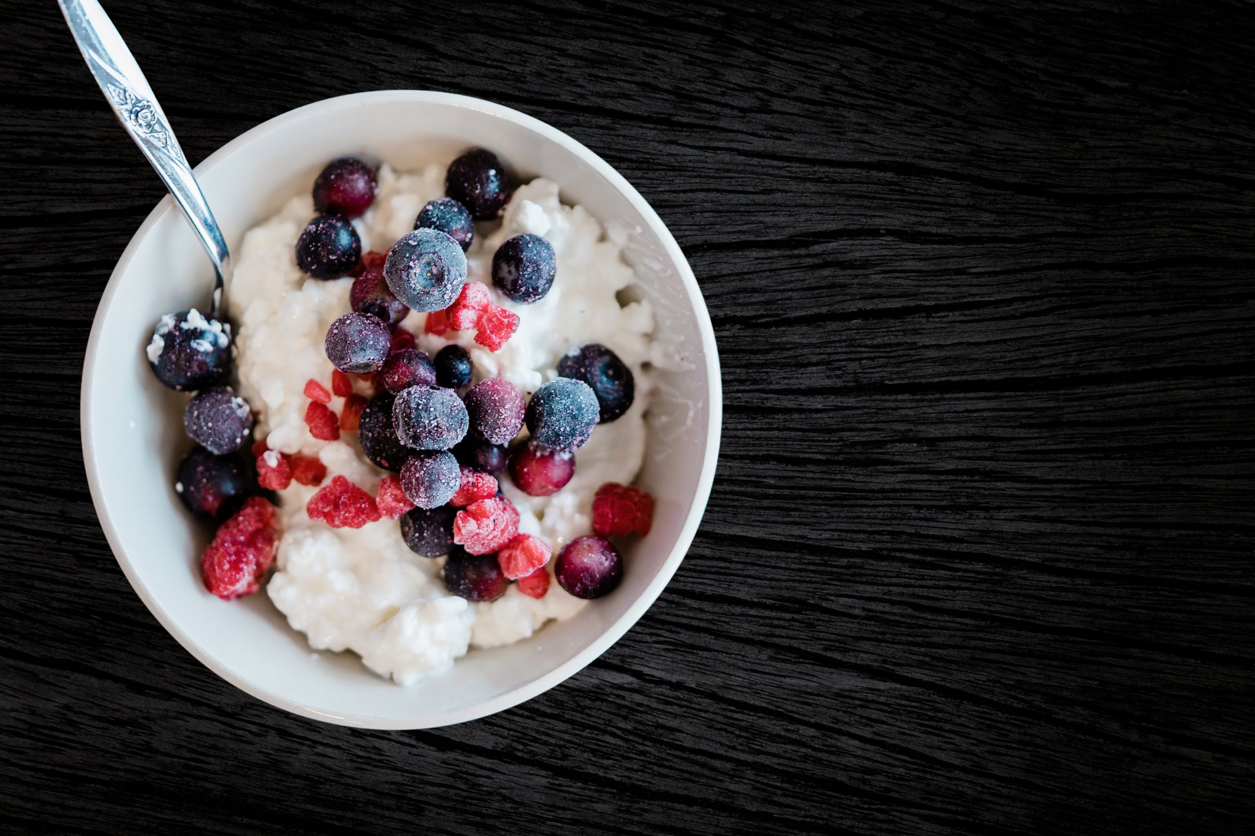 Enjoy a healthy breakfast with cottage cheese topped with fresh berries, perfect for a nutritious start.