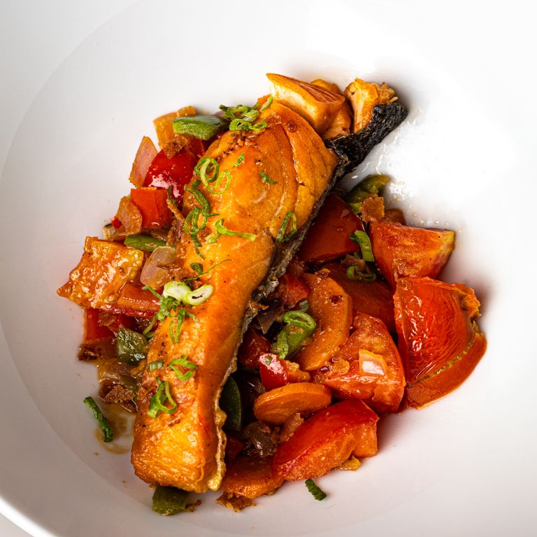 Grilled salmon fillet served with vibrant fresh vegetables, perfect for a healthy meal.