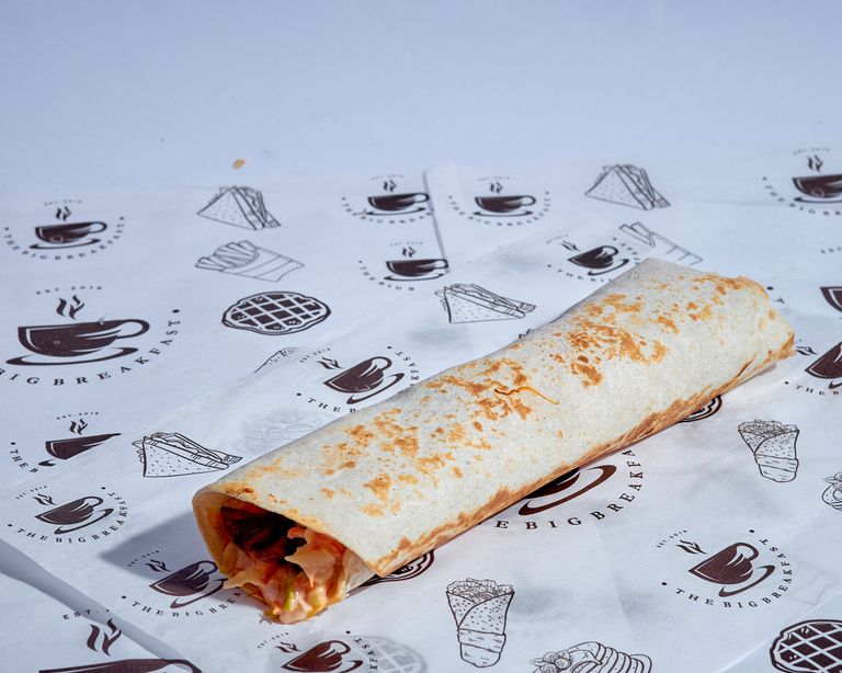 Tasty breakfast wrap served on branded paper, ideal for quick meals.